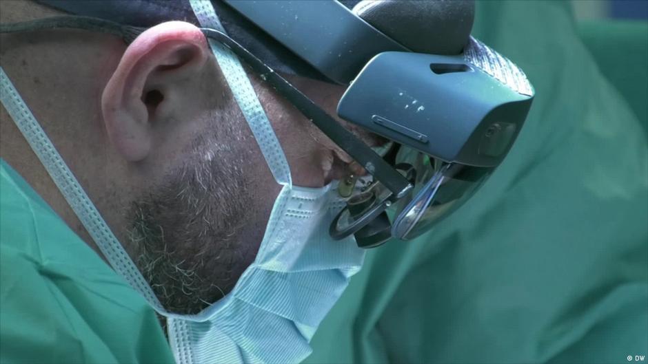 Surgeon wearing augmented reality glasses during an operation, from the DW video